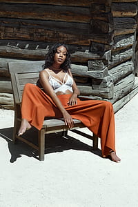 woman sitting on brown wooden chair thumbnail