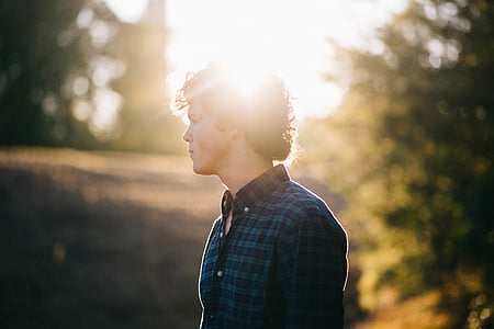 man wearing blue and green plaid dress shirt during daytime forced focus photography thumbnail