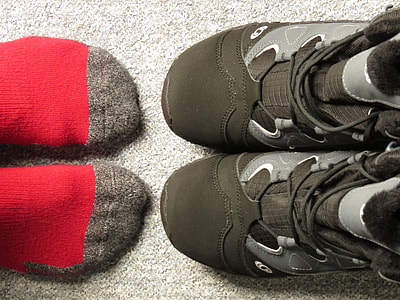 pair of red socks in front of pair of black shoes thumbnail