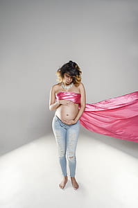 woman standing near white painted wall thumbnail