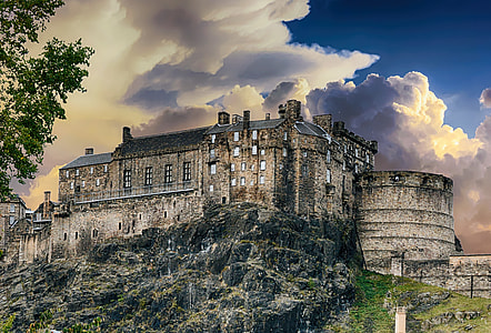 gray castle on hill under white clouds thumbnail