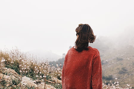 woman in red top near white petaled flowers under cloudy sky during daytime thumbnail