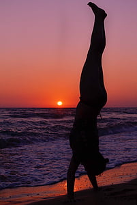 silhouette of man beside seashore during sunset thumbnail