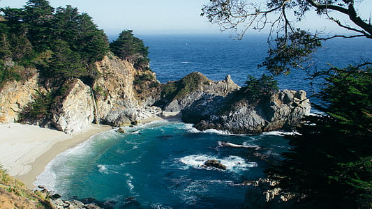 photo of shore and body of water during daytime thumbnail