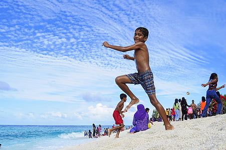 boy wearing black shorts jumping thumbnail