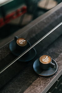 black ceramic cup on black ceramic saucer thumbnail