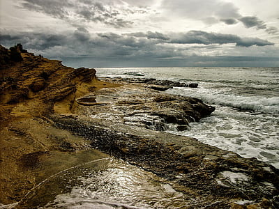 body of water near rock formation thumbnail