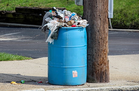 blue plastic container filled with garbage thumbnail