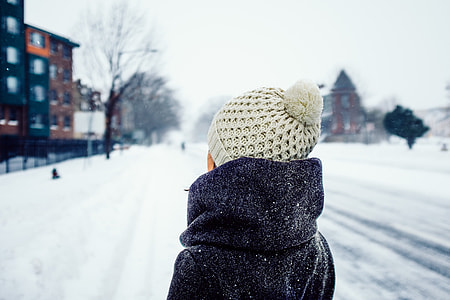 shallow focus photography of person facing snow covered road thumbnail