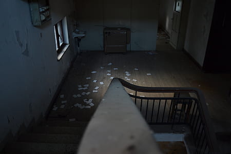 brown handrails beside brown wooden floor with white papers thumbnail