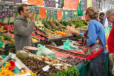 woman standing in front of vegetable store thumbnail