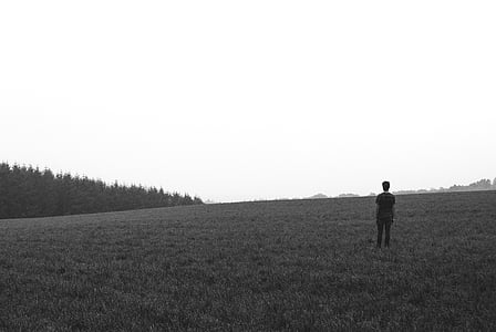person standing on grass field during daytime thumbnail
