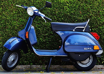 blue motor scooter parked on sidewalk thumbnail