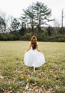 photo of woman in white dress standing on grass thumbnail