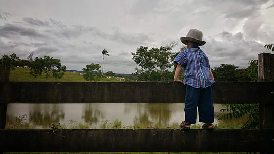 boy standing on fence thumbnail