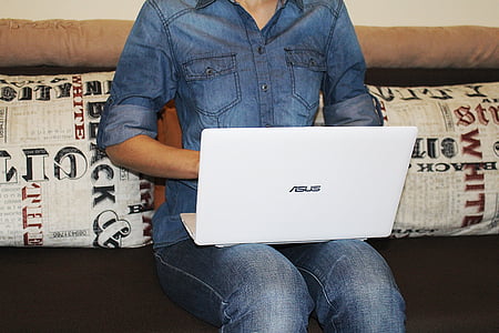 woman sitting with Asus laptop on her lap thumbnail