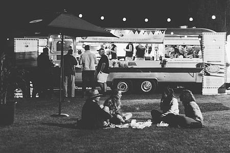 four people sitting on grass thumbnail