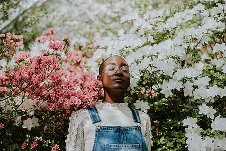 woman wearing top near flowers thumbnail