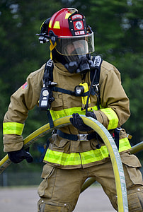 man wearing bunker suit holding hose thumbnail