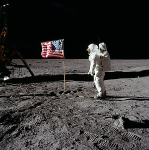 astronaut on moon in front of American flag photo thumbnail