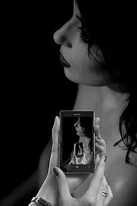 grayscale photo of woman in Nokia Windows smartphone thumbnail