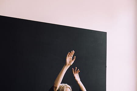 person raising it's hands indoors thumbnail