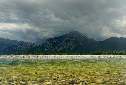 body of water near mountain thumbnail