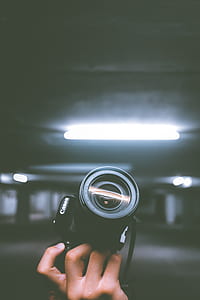 person holding black Canon DSLR camera thumbnail