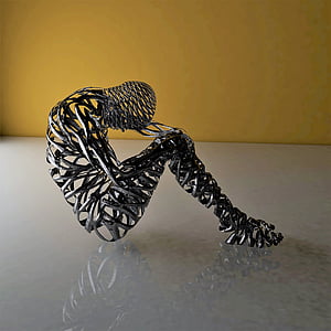 person lifting his head through his knee wired figurine thumbnail