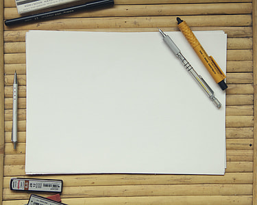 white paper beside pens and erasers on top of brown wooden surface thumbnail