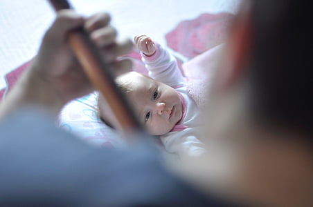 man playing instrument in front of baby thumbnail
