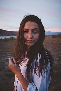 smiling woman in white shirt looking sideways thumbnail