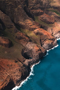 aerial photography of cliff near seashore during daytime thumbnail