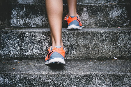 person stepping on stairs at daytime thumbnail