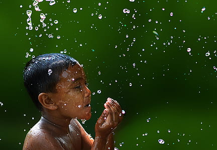 Wet Boy With Water Droplets in Slow Motion Photography thumbnail
