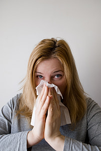 woman sneezing on white tissue paper thumbnail