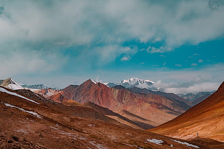 mountains under blue sky and white clouds at daytime thumbnail