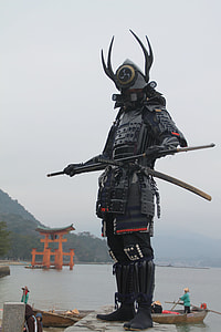 Samurai on gray concrete near body of water during daytime thumbnail
