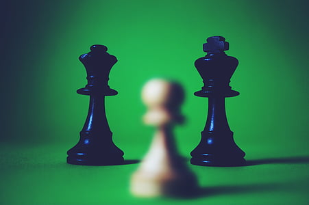 selective focus photography of three black and brown chess pieces thumbnail