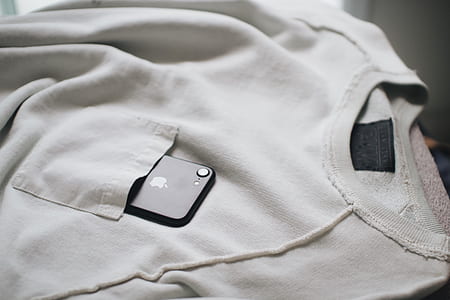 space gray iPhone 7 inside pocket of gray crew-neck shirt thumbnail