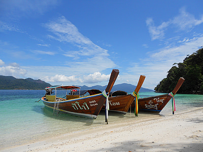three brown passenger boats in seashore thumbnail