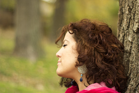woman leaning on brown tree thumbnail