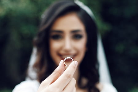 woman holding silver-colored ring thumbnail