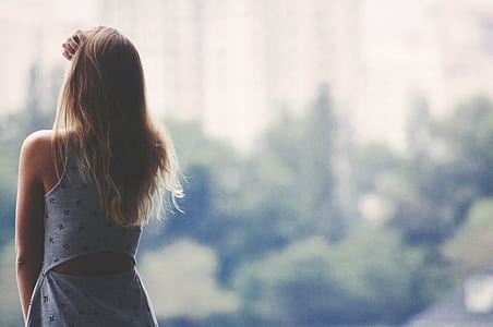 woman holding head selective focus photography thumbnail