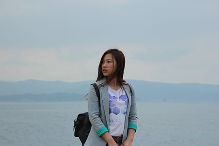 woman standing near body of water thumbnail