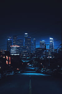 driveway overlooking high-rise buildings under nighttime sky thumbnail