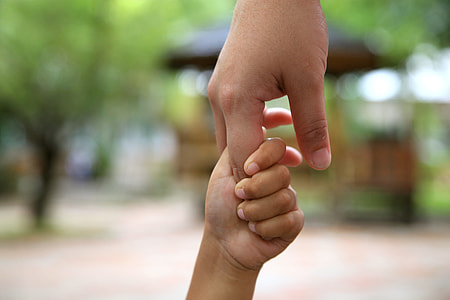 person and children's hand thumbnail