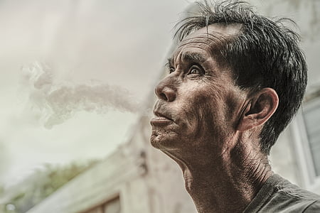 man puffing out smoke on his mouth thumbnail