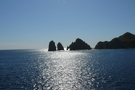 rock formations on body of water at daytime thumbnail