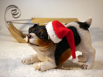 brown and black ceramic dog figurine with Santa hat thumbnail